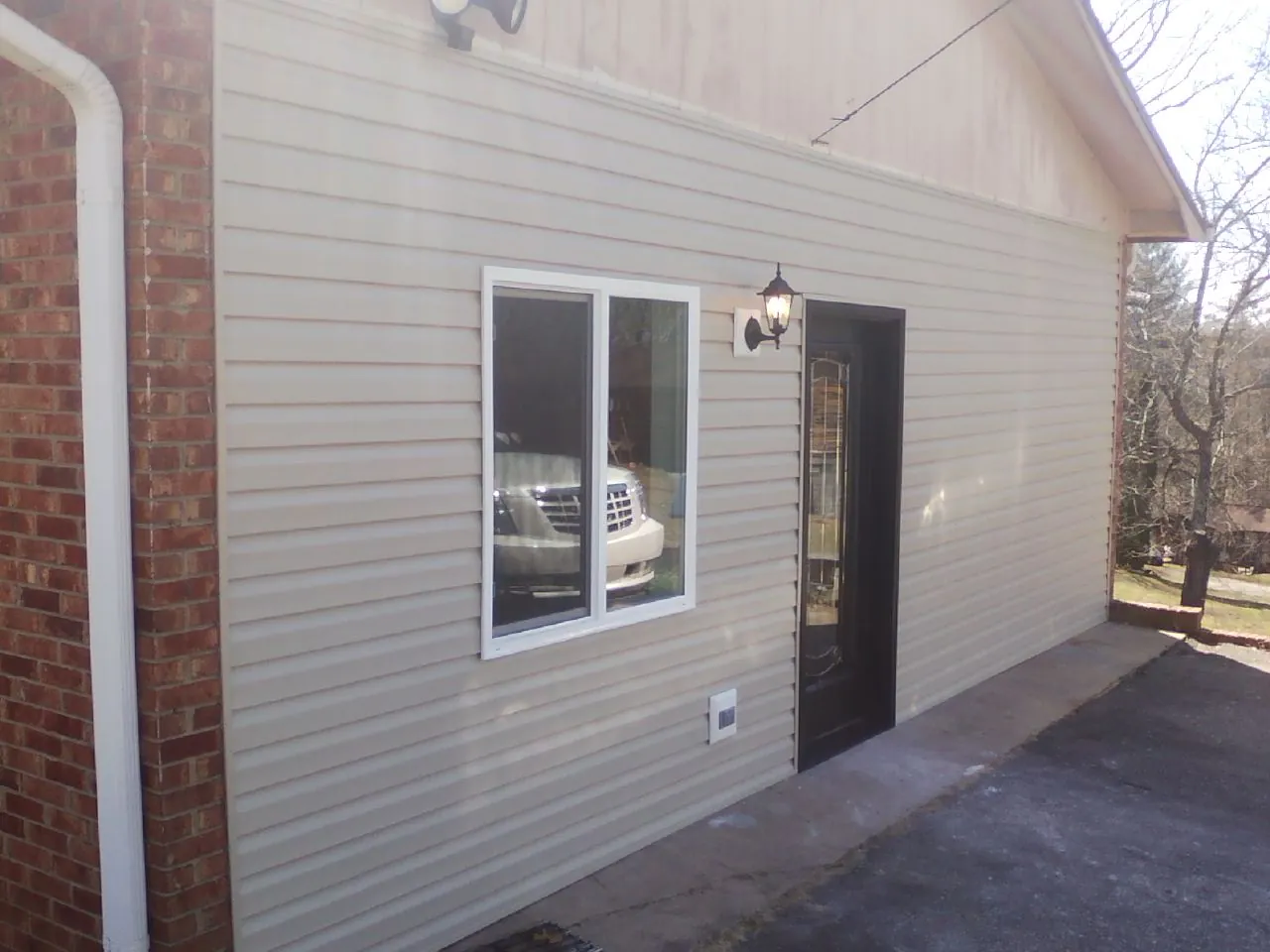 New vinyl siding and entry door on a room addition in Sterling